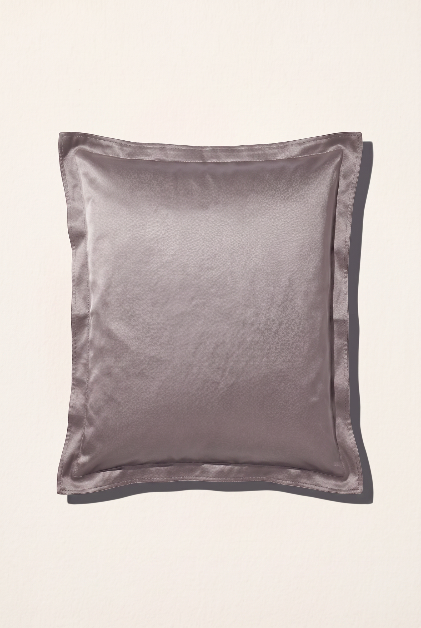 Taupe silk pillowcase on a white background