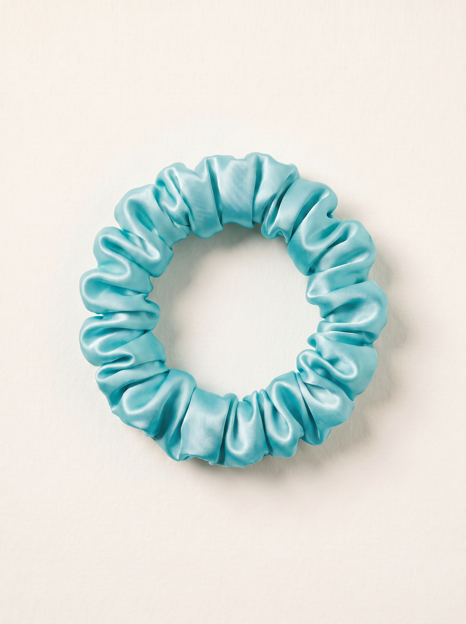 Ivory and dusty rose silk material arranged in sculptural loops