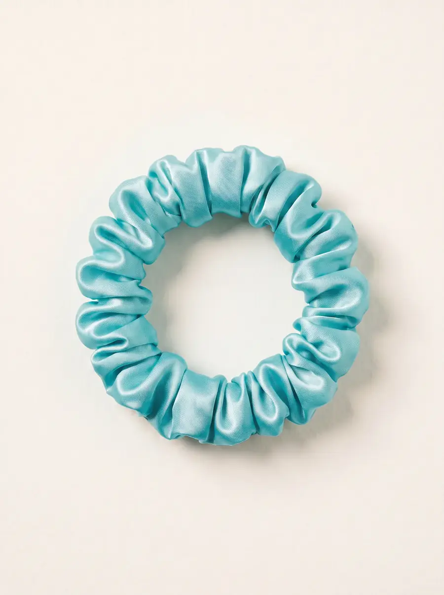 Ivory and dusty rose silk material arranged in sculptural loops